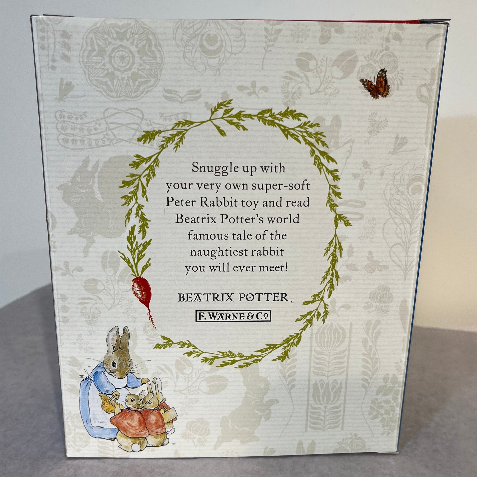 Back of gift package holding Peter Rabbit book and rabbit toy